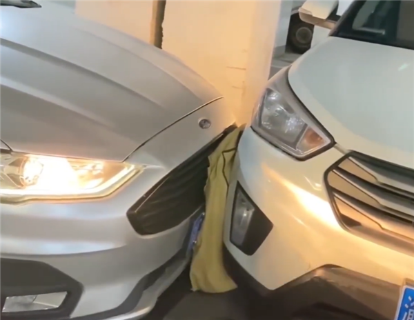 男子車位被堵打電話對方關(guān)機 使出奇招：墊棉被頂開車子成功出庫